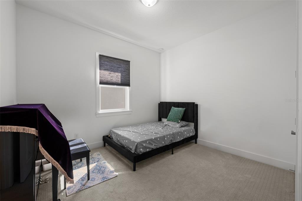 9185 Sanders Tree Loop Wesley Chapel, FL 33545 - Photo 24 of 47 a bedroom with a bed and a window