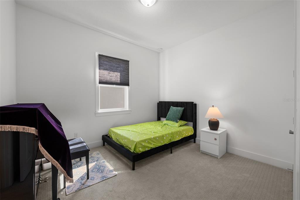 9185 Sanders Tree Loop Wesley Chapel, FL 33545 - Photo 25 of 48 a bedroom with a bed and a window