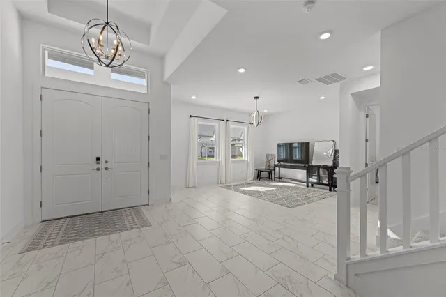 a view of a livingroom with a furniture wooden floor and a chandelier