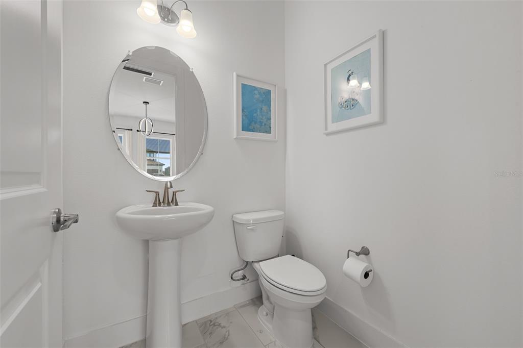 9185 Sanders Tree Loop Wesley Chapel, FL 33545 - Photo 31 of 47 a bathroom with a toilet sink and mirror