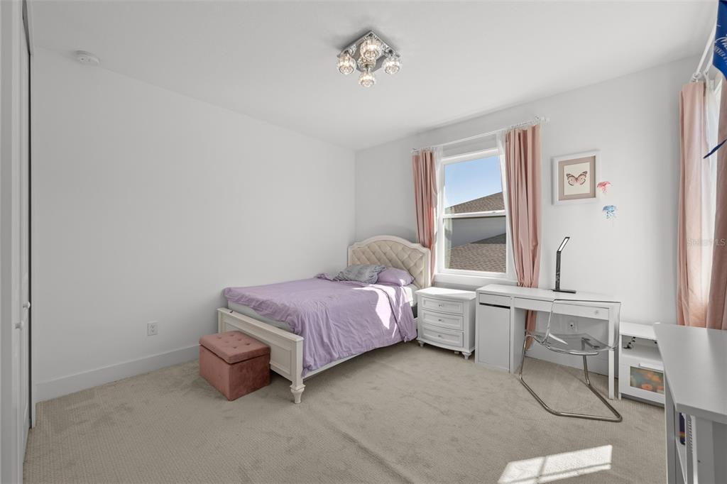 9185 Sanders Tree Loop Wesley Chapel, FL 33545 - Photo 31 of 48 a bedroom with a bed and a window