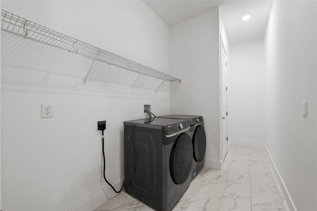 9185 Sanders Tree Loop Wesley Chapel, FL 33545 - Photo 33 of 47 a utility room with dryer and washer