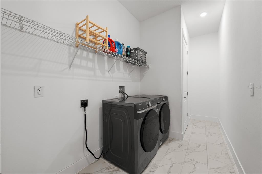 9185 Sanders Tree Loop Wesley Chapel, FL 33545 - Photo 34 of 48 a utility room with dryer and washer