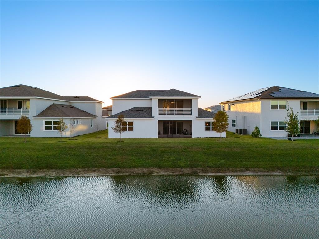 9185 Sanders Tree Loop Wesley Chapel, FL 33545 - Photo 37 of 47 a front view of a house with a yard and garage
