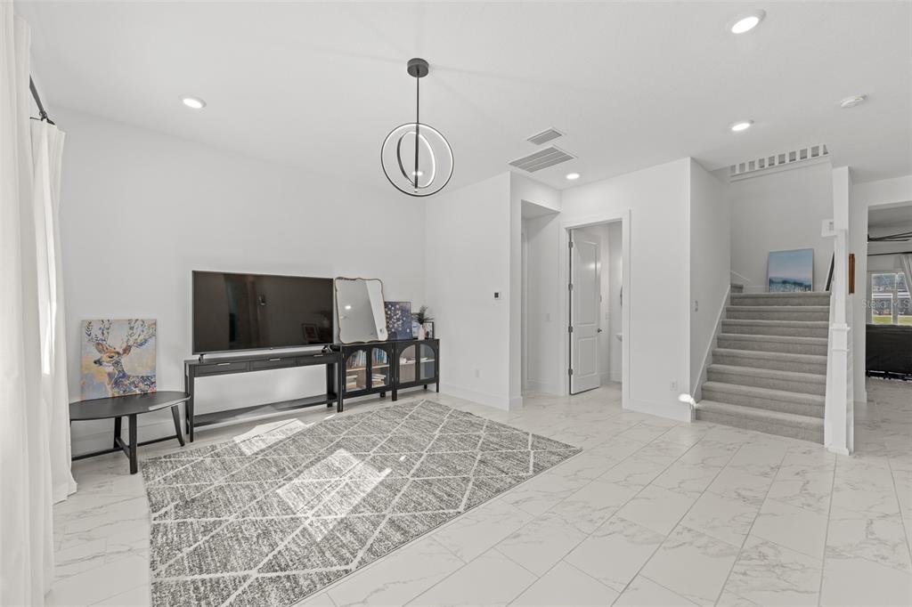 9185 Sanders Tree Loop Wesley Chapel, FL 33545 - Photo 4 of 48 a view of a livingroom with wooden floor and furniture