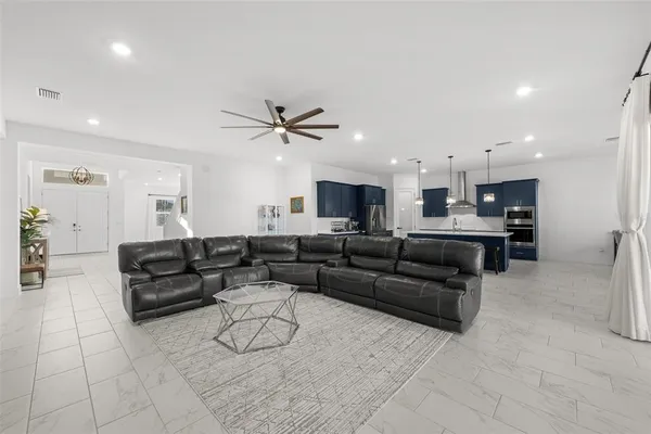 a large kitchen with stainless steel appliances wooden cabinets and a stove top oven