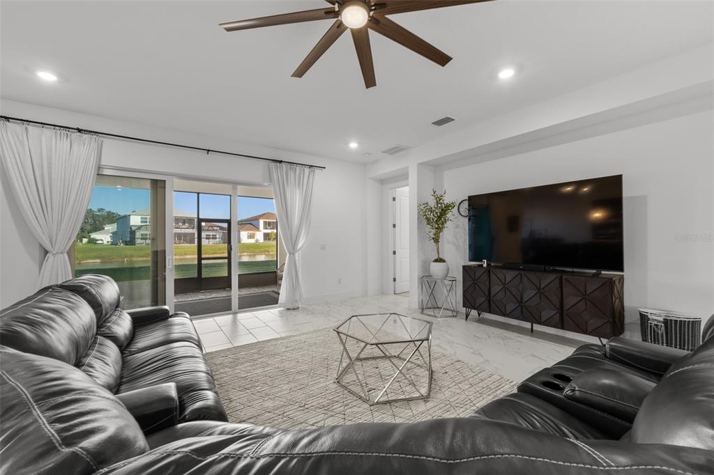 9185 Sanders Tree Loop Wesley Chapel, FL 33545 - Photo 6 of 48 a living room with furniture and a flat screen tv