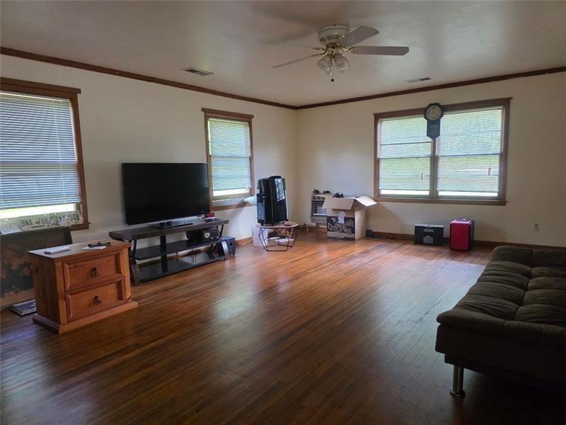 3834 Highway 124 Jefferson, GA 30549 - Photo 2 of 12 a living room with furniture and a flat screen tv