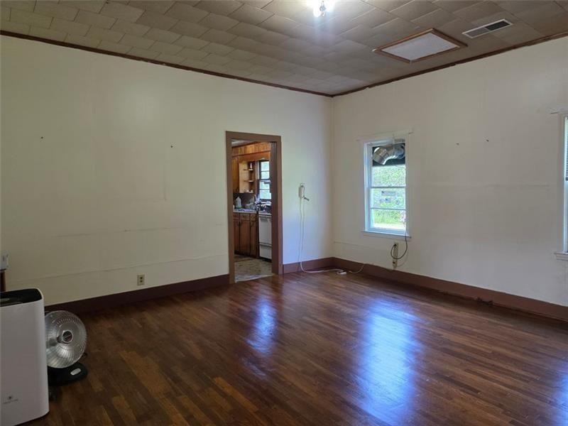 3834 Highway 124 Jefferson, GA 30549 - Photo 7 of 12 an empty room with wooden floor and windows