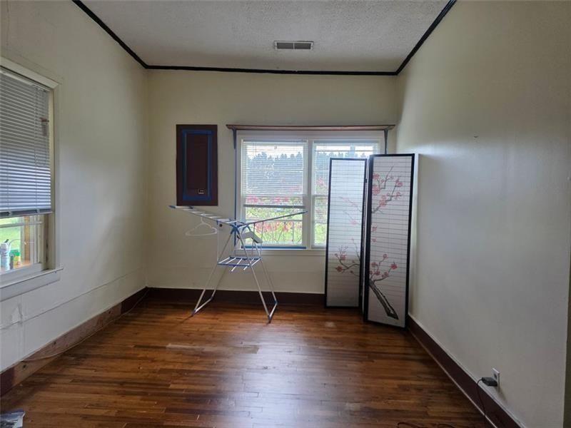 3834 Highway 124 Jefferson, GA 30549 - Photo 8 of 12 an empty room with wooden floor and windows