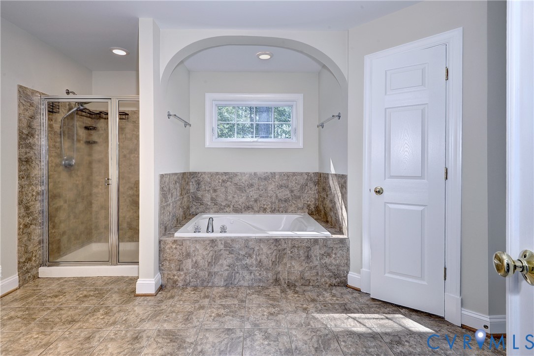 11385 Winding River Road Providence Forge, VA 23140 - Photo 30 of 43 a spacious bathroom with a bathtub and a shower