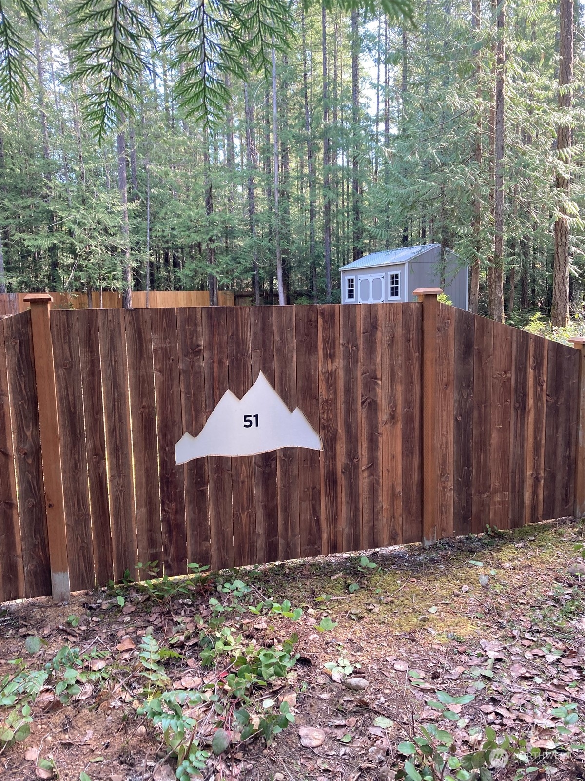 a wooden fence with a small yard