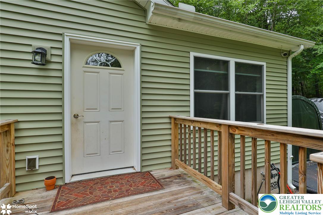A well-maintained wooden deck welcomes guests to this inviting home.
