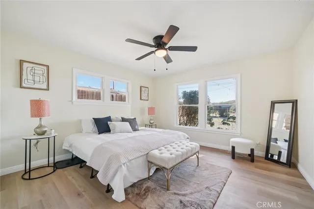 a bedroom with a bed and wooden floor