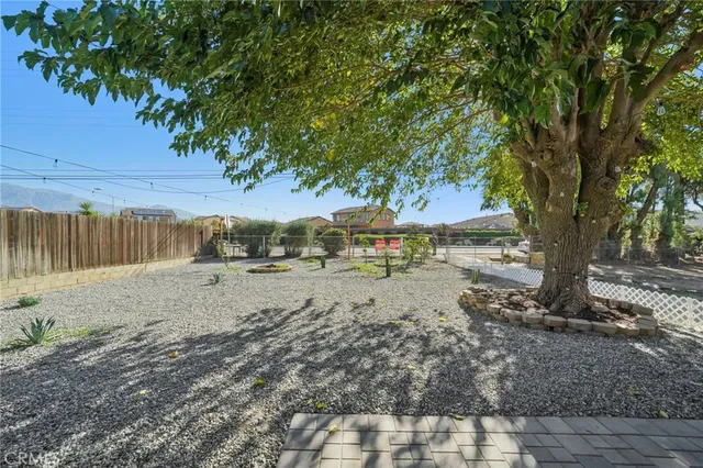a view of a yard with wooden fence