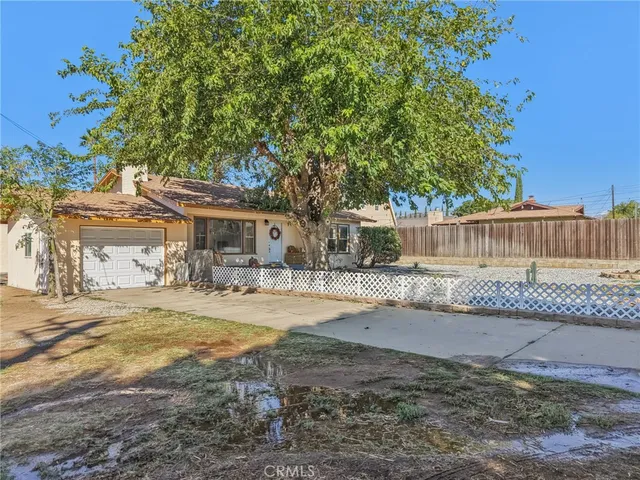 a view of a house with a yard and sitting area