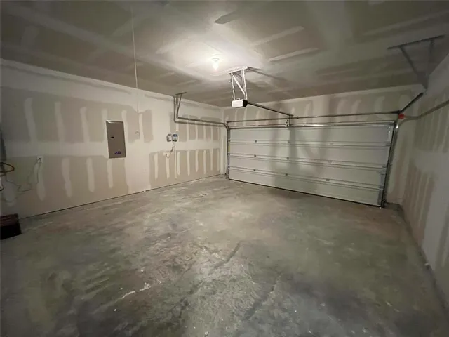 a utility room with wooden floor washer and dryer