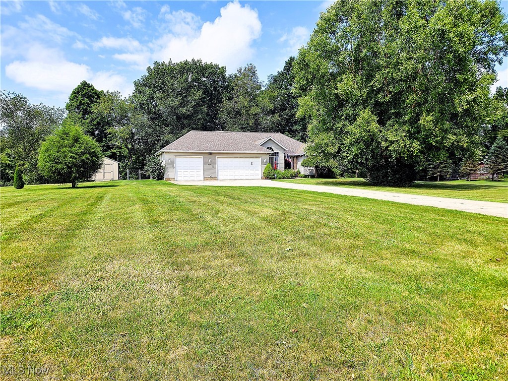 8329 Seasons Road Streetsboro, OH 44241 - Photo 2 of 35 View of front of property featuring a front yard and a garage