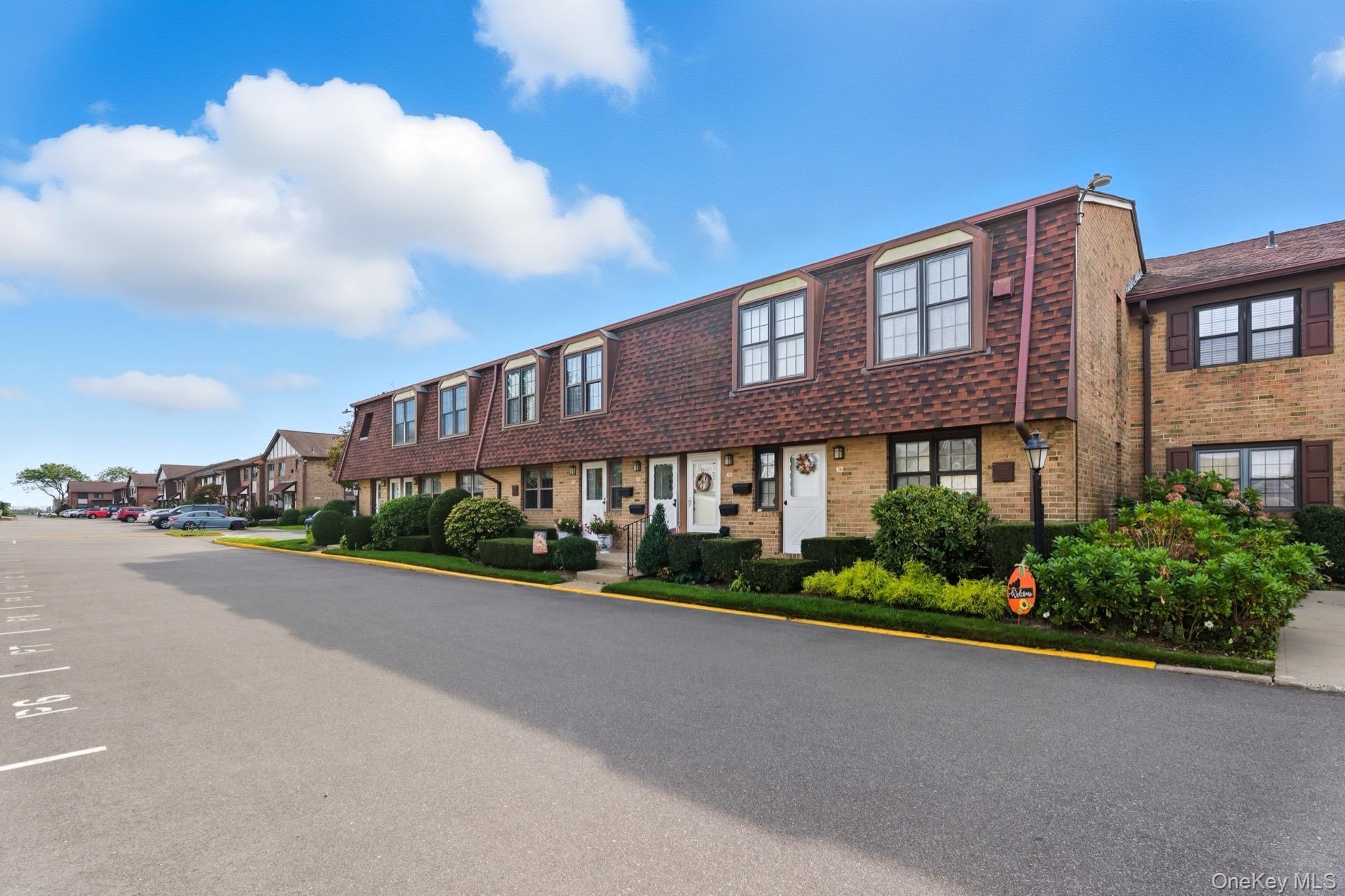 348 Mariners Way Copiague, NY 11726 - Photo 2 of 19 View of building exterior front facing east