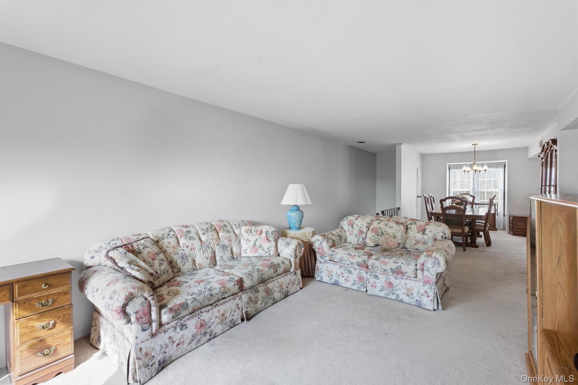 348 Mariners Way Copiague, NY 11726 - Photo 5 of 19 Carpeted living area/ HW Floors beneath