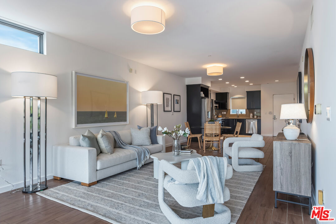 13045 Pacific Promenade, Unit 330 Los Angeles, CA 90094 - Photo 12 of 43 a living room with furniture and a large mirror with wooden floor