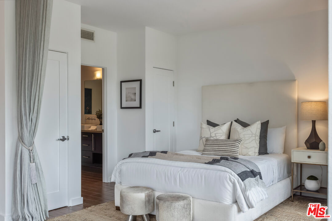 13045 Pacific Promenade, Unit 330 Los Angeles, CA 90094 - Photo 17 of 43 a bedroom with a bed and a lamp on dresser