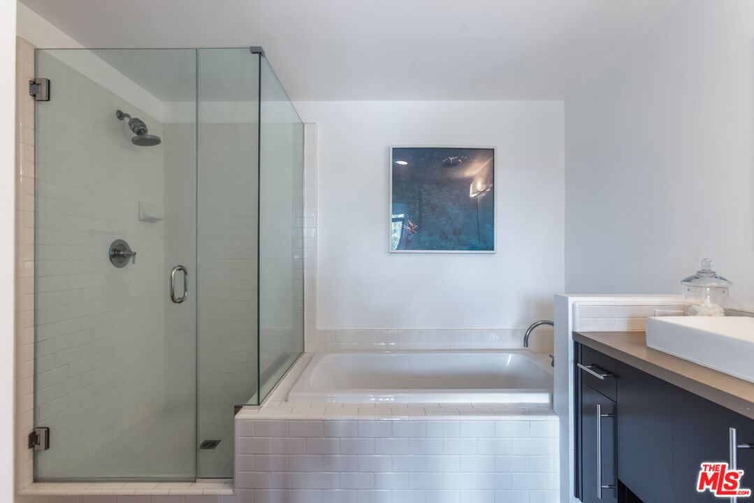 13045 Pacific Promenade, Unit 330 Los Angeles, CA 90094 - Photo 19 of 43 a bathroom with a sink a toilet and shower