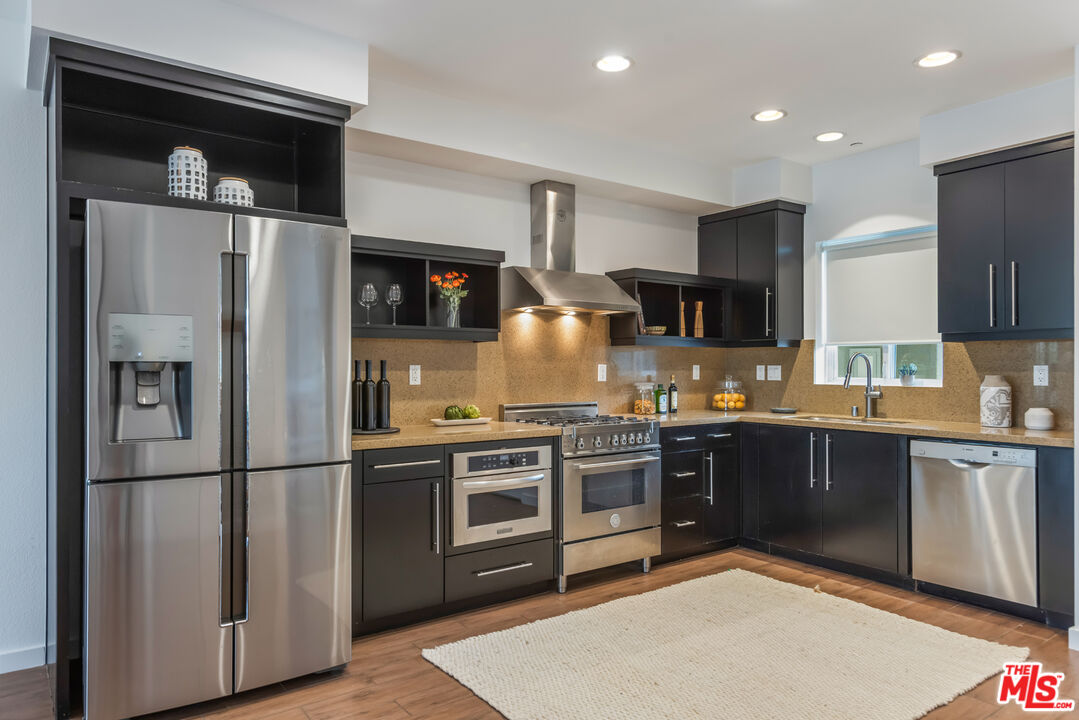 13045 Pacific Promenade, Unit 330 Los Angeles, CA 90094 - Photo 5 of 43 a kitchen with stainless steel appliances granite countertop a refrigerator a stove top oven a sink and dishwasher