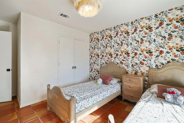 a bedroom with a bed and a dresser