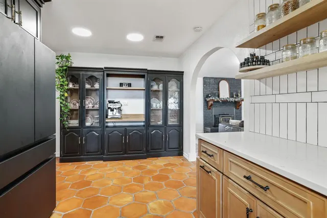 a kitchen with stainless steel appliances granite countertop a refrigerator and cabinets