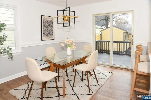 a view of a dining room with furniture and a window