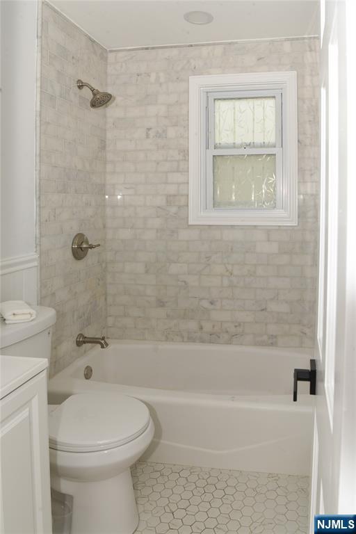 47 Elston Street Bloomfield, NJ 07003 - Photo 16 of 38 a bathroom with a toilet and a bath tub