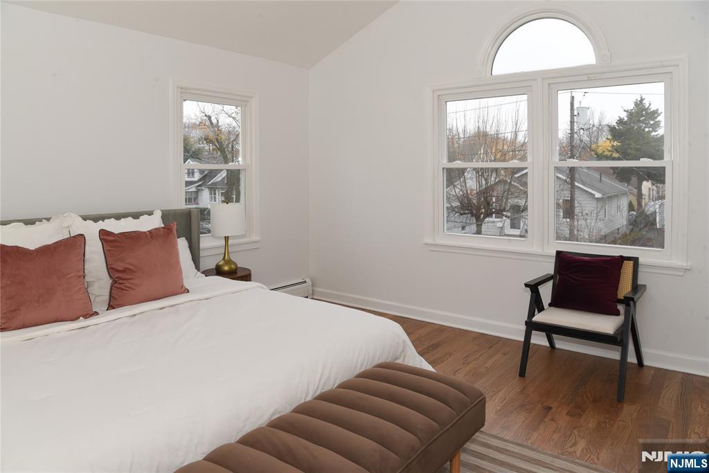 47 Elston Street Bloomfield, NJ 07003 - Photo 19 of 38 a bedroom with a bed and a window