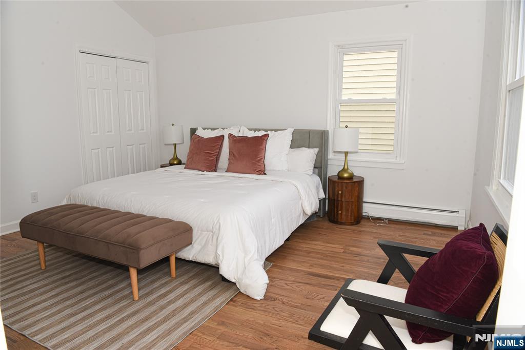 47 Elston Street Bloomfield, NJ 07003 - Photo 20 of 38 a bedroom with a bed and a chair