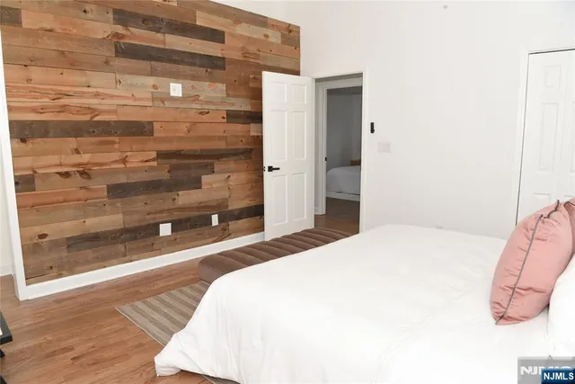 a bedroom with a bed and a mirror