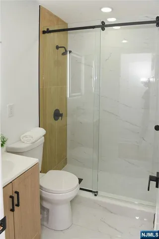 a bathroom with a shower a toilet and a sink