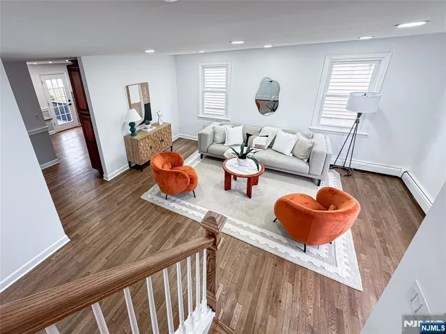 a living room with furniture and a large mirror