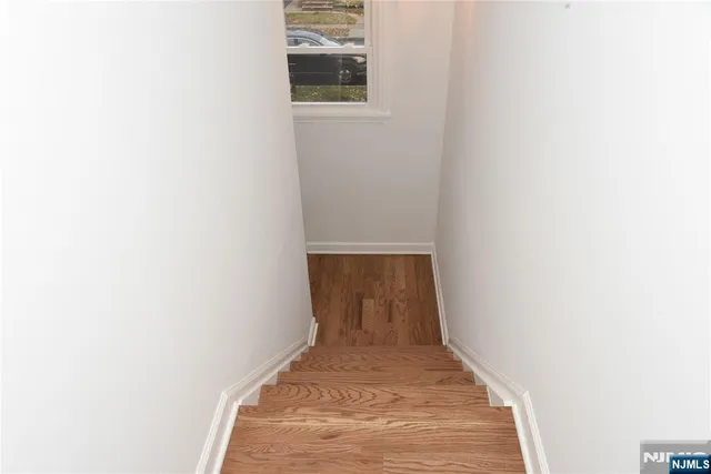 a view of a room with wooden floor