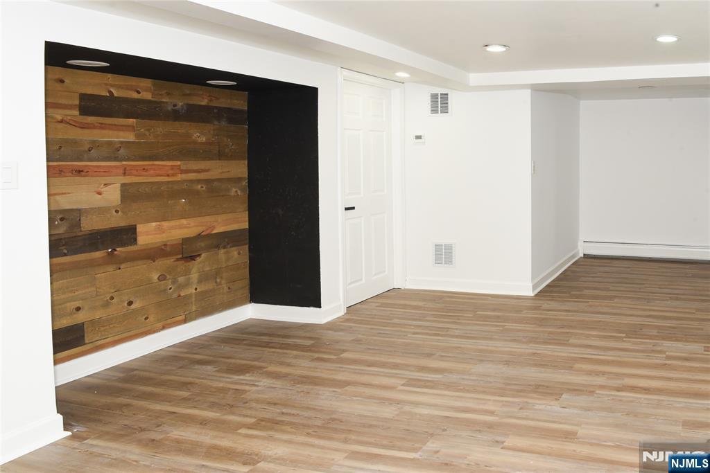 47 Elston Street Bloomfield, NJ 07003 - Photo 33 of 38 a view of an empty room with wooden floor and a window