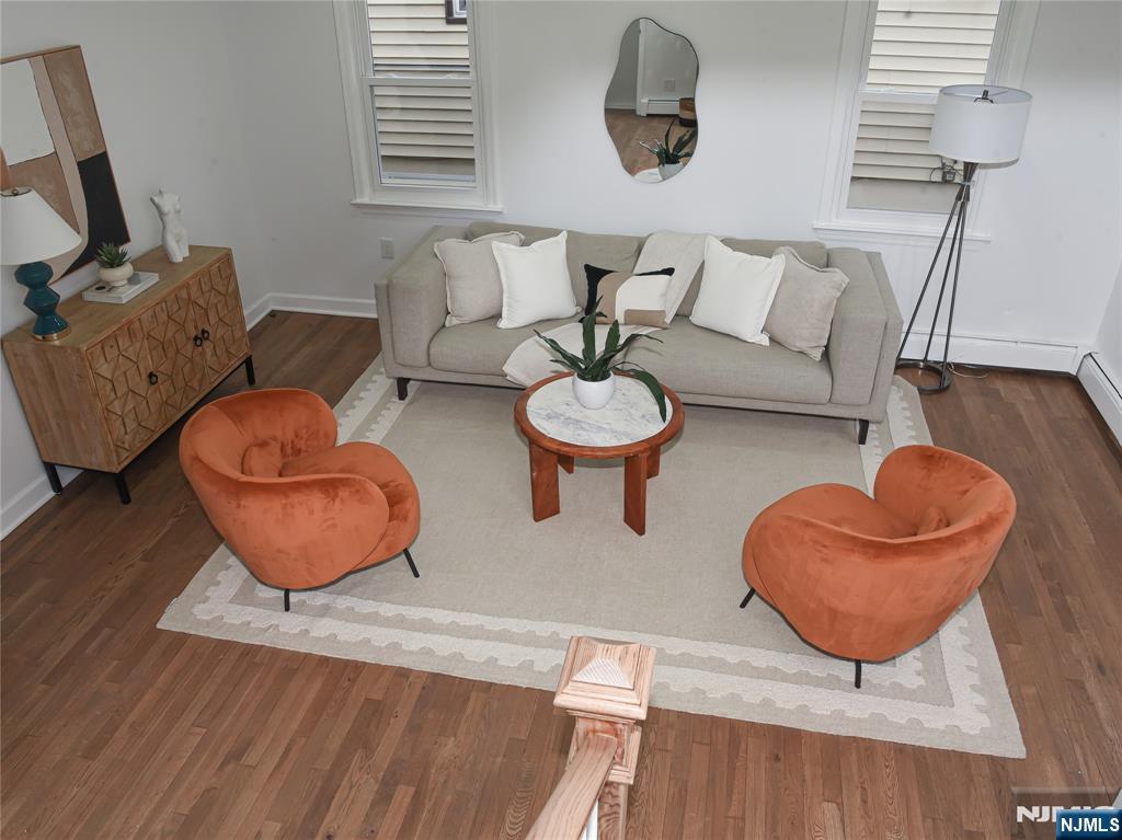 47 Elston Street Bloomfield, NJ 07003 - Photo 8 of 38 a living room with furniture and a chair