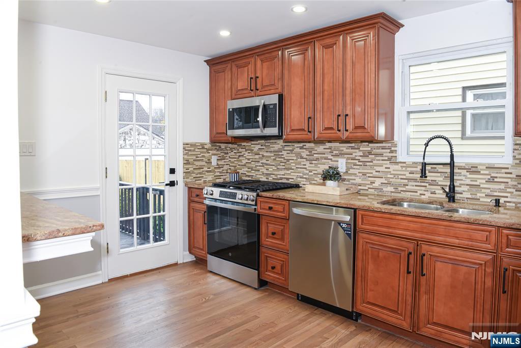 47 Elston Street Bloomfield, NJ 07003 - Photo 10 of 38 a kitchen with stainless steel appliances granite countertop a sink stove and cabinets