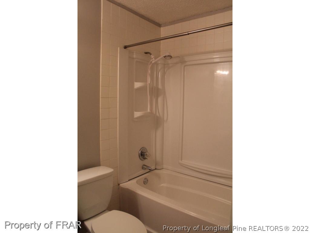 6490 Green Meadow Road Fayetteville, NC 28304 - Photo 12 of 22 a bathroom with a toilet and a shower