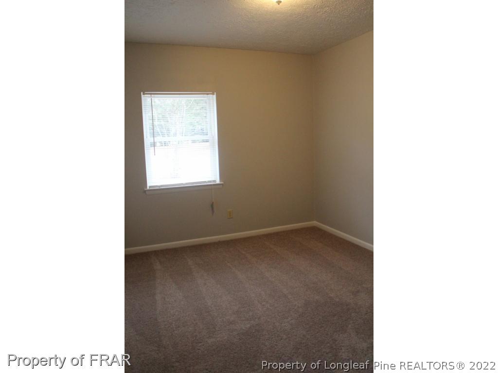 6490 Green Meadow Road Fayetteville, NC 28304 - Photo 14 of 22 a view of an empty room with a window