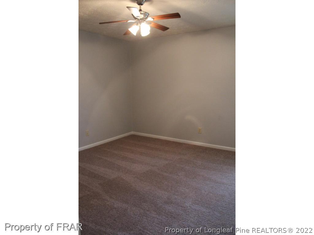 6490 Green Meadow Road Fayetteville, NC 28304 - Photo 16 of 22 a view of a room with a ceiling fan