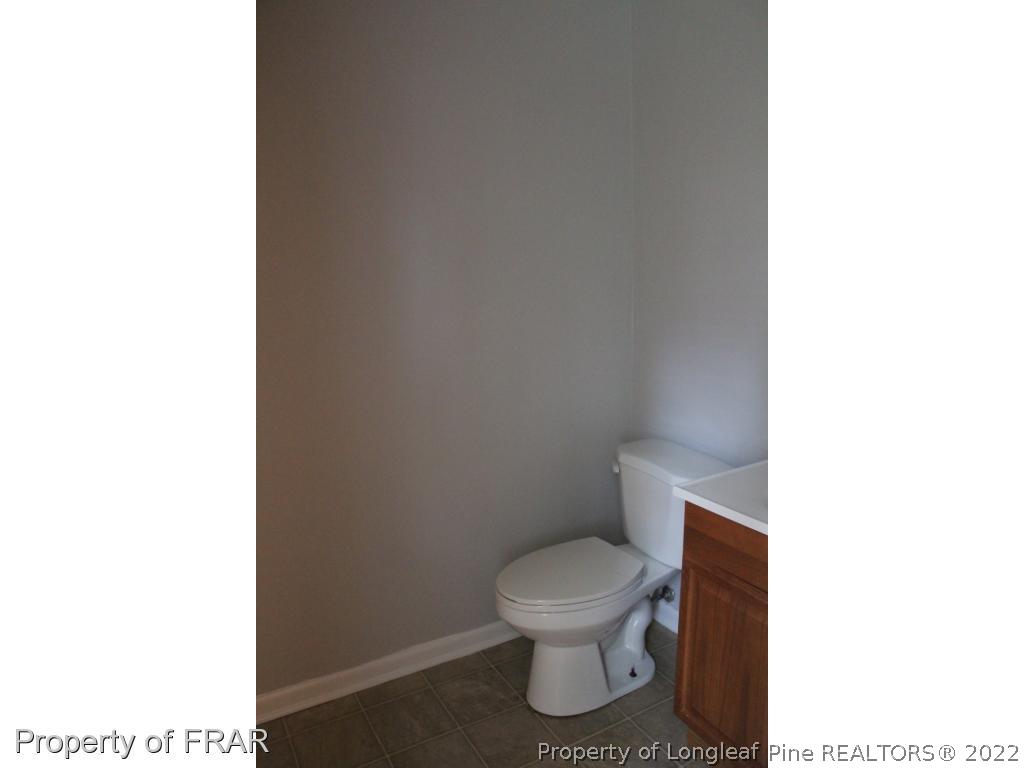 6490 Green Meadow Road Fayetteville, NC 28304 - Photo 19 of 22 a bathroom with a toilet and a sink