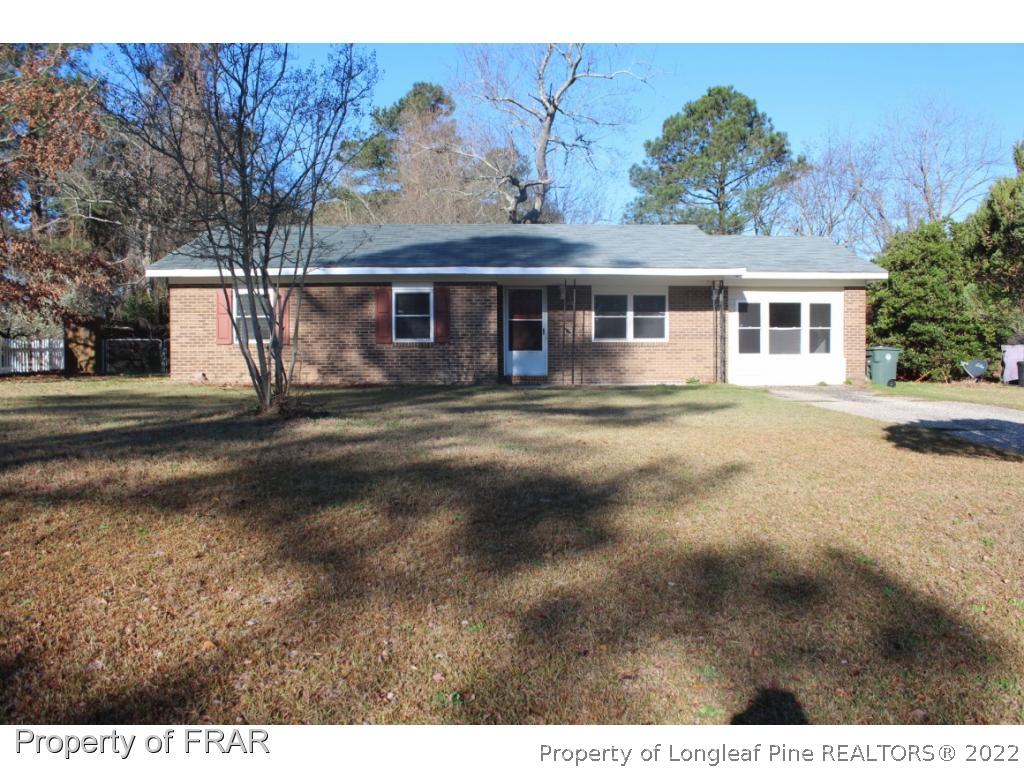 6490 Green Meadow Road Fayetteville, NC 28304 - Photo 2 of 22 a front view of a house with a garden