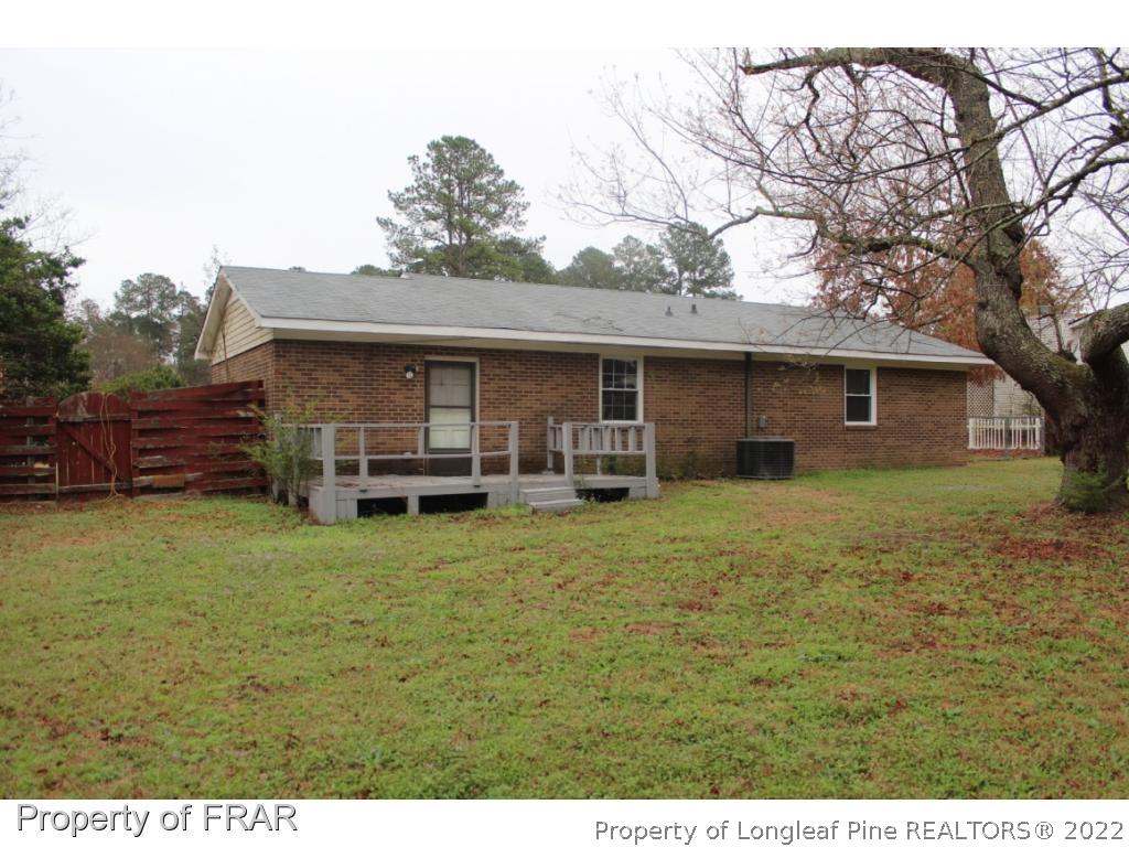 6490 Green Meadow Road Fayetteville, NC 28304 - Photo 21 of 22 a front view of a house with a garden