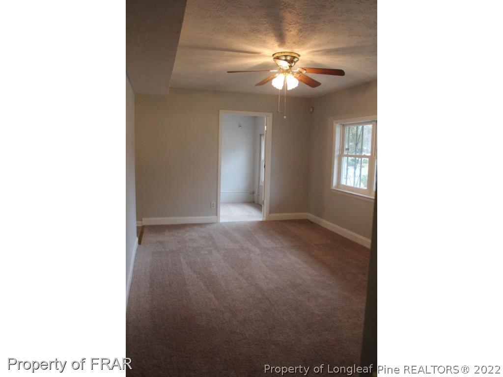 6490 Green Meadow Road Fayetteville, NC 28304 - Photo 3 of 22 a view of a livingroom with a ceiling fan