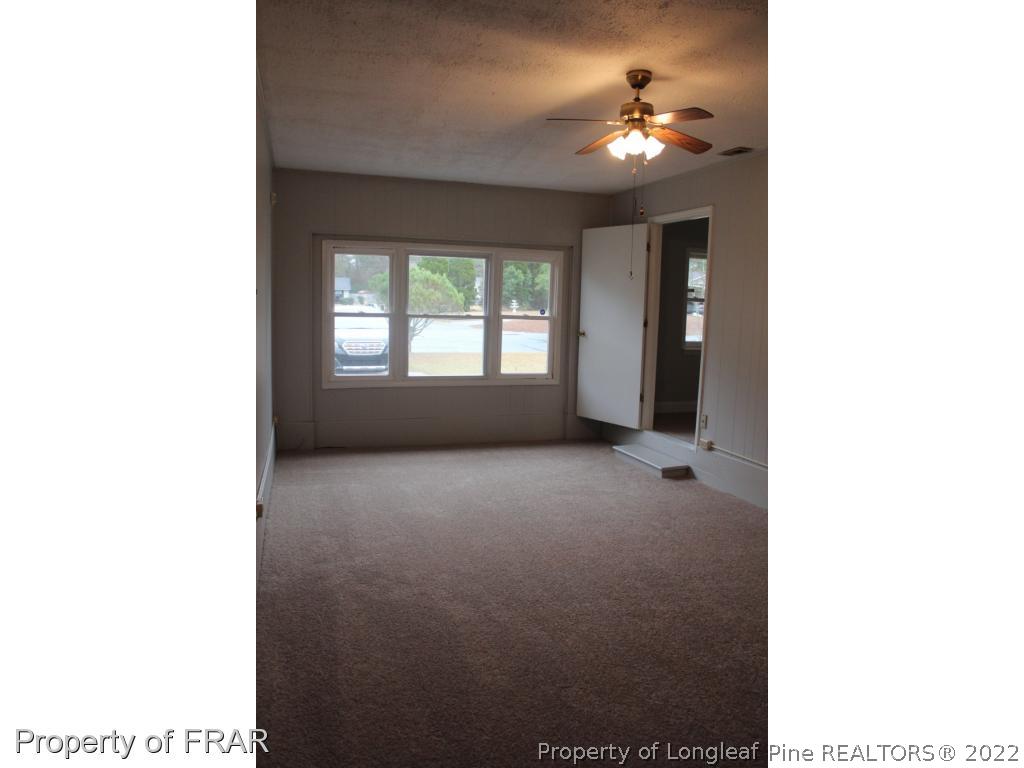 6490 Green Meadow Road Fayetteville, NC 28304 - Photo 8 of 22 a view of a room with a ceiling fan and window