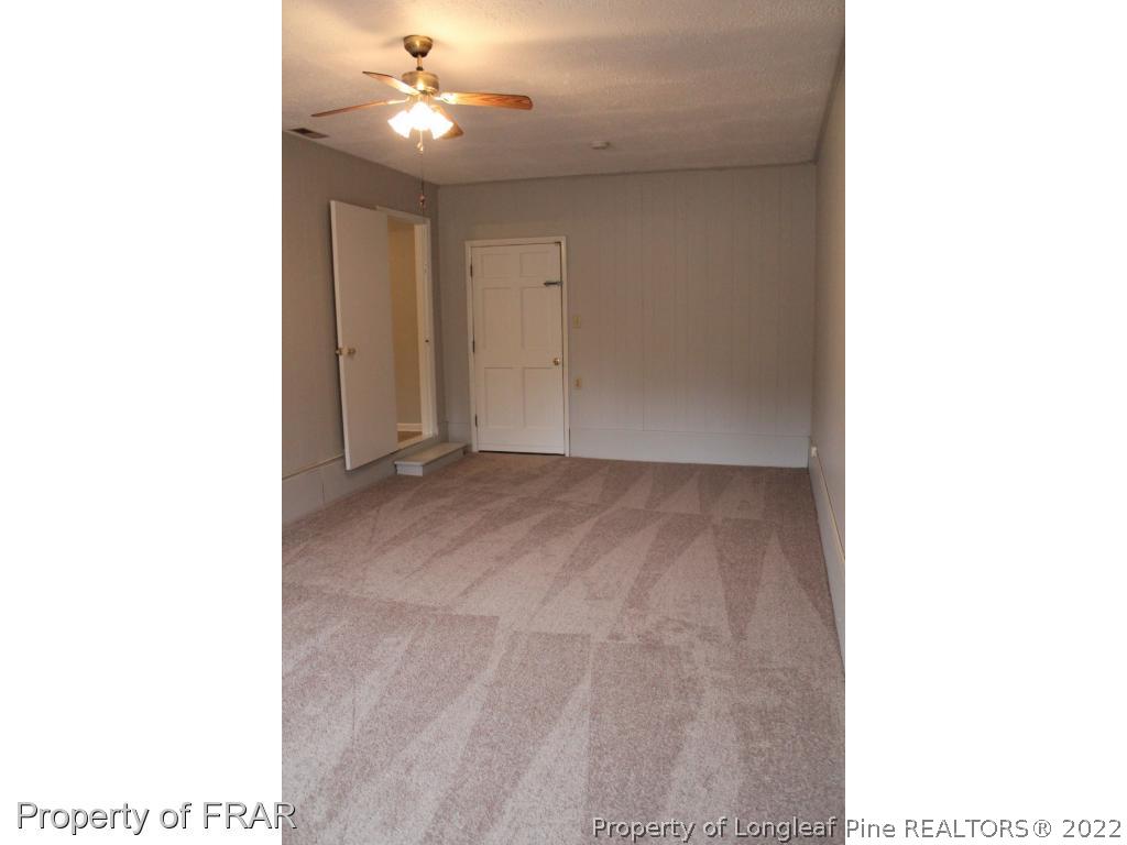 6490 Green Meadow Road Fayetteville, NC 28304 - Photo 9 of 22 a view of an empty room with chandelier fan